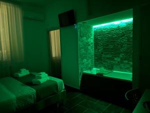 a bathroom with a bed and a sink and a mirror at Mirellas dream in Vibo Valentia