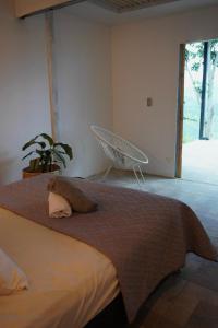 a bedroom with a bed and a chair in it at Villa Bonaire - tobia in Tobia