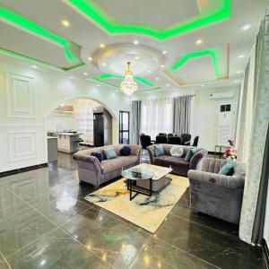 a living room with green lights on the ceilings at Cité La Vie in Douala