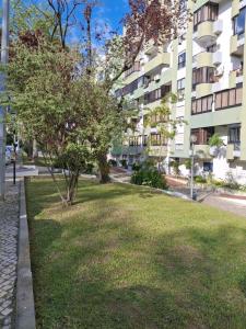 a park in front of a apartment building at Almada Apartment in Almada