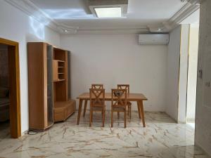 a dining room with a table and two chairs at Résidence Mabrouka in Qaşr Chouline +13 photos