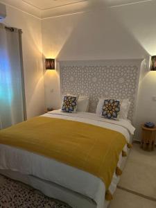a bedroom with a large bed with pillows on it at Riad Dar Fena By K&G &jacuzzi in Marrakech