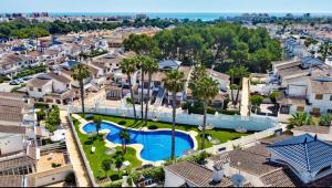 an aerial view of a resort with a swimming pool at Chalet adosado en RIOMAR-3, urbanización residencial privada in La Horadada +36 photos