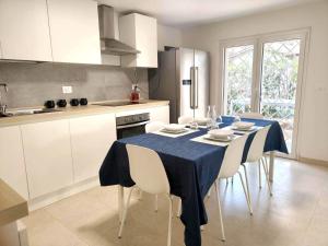 a kitchen with a table with a blue table cloth on it at Villino Ambra in Marina di Pietrasanta