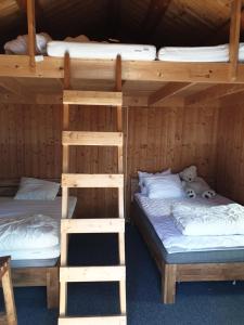 a bedroom with two bunk beds and a teddy bear at Holiday Raustua Cabin in Gol