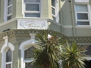 a building with a sign on the side of it at The Boho - 4 min walk to beach & town in Bournemouth
