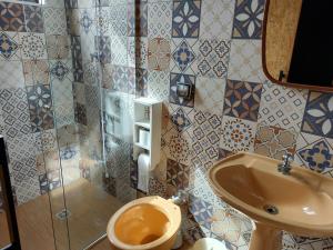 a bathroom with a toilet and a sink at Casa Container in Águas de Lindoia +24 photos