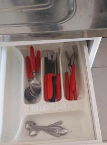 a drawer filled with utensils in a cabinet at Apto 1 Central em Fátima do Sul térreo in Fatima do Sul