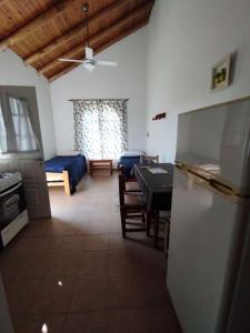 a kitchen and dining room with a refrigerator and a table at Cabañas azahares del Ayui in Concordia