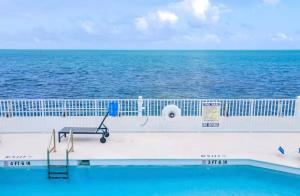 a swimming pool on a cruise ship overlooking the ocean at Hooked on Islamorada Oceanfront Townhome, Private Dock, Pool in Islamorada