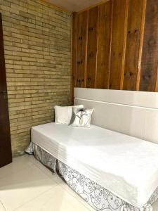 two beds sitting next to each other in a room at Recanto Amado in Araucária +16 photos