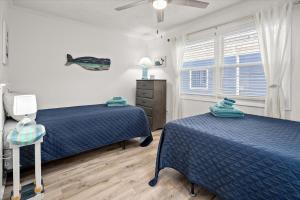 a bedroom with two beds and a window at Ocean Whisperers, 5 min Walk to Boardwalk & Beach, Just Renovated 2025 in Ocean City