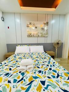 a bedroom with a bed with towels on it at Santa Ana Transient House in Sampong