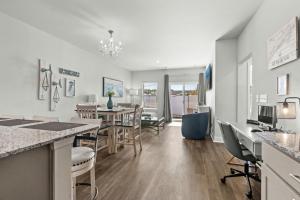 a kitchen and dining room with a table and chairs at Little River 3BR Villa with Outdoor Movies & Fire Pit, Indoor Fire Place, Arcades, & Beach! in Little River