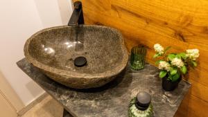 a bathroom sink with flowers on a counter at Sun x Mountains - Old Town in Braşov +16 photos