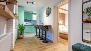 a room with a kitchen and a bedroom with a bed at Sun x Mountains - Old Town in Braşov