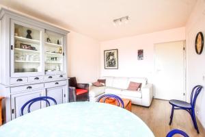 a living room with a table and a couch at Hoge 0410 in Koksijde