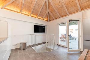 a living room with a staircase and a tv at Casa Largo, Town Centre in Tavira