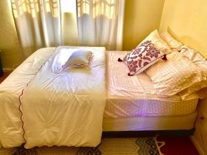 a bed with two pillows on it in a bedroom at Karibu House in Tucson