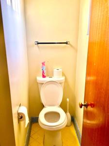 a bathroom with a toilet with a roll of toilet paper at Karibu House in Tucson