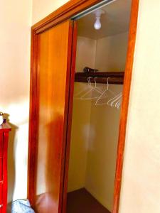 a glass door of a closet with a hanger at Karibu House in Tucson