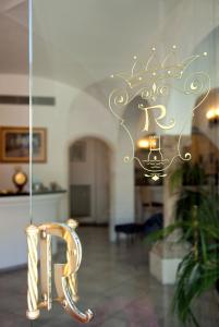 a gold chair in a room with a chandelier at Hotel Reginella in Positano