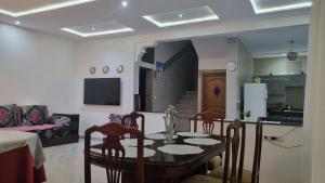 a dining room and kitchen with a table and chairs at La suite taghazout in Taghazout +35 photos