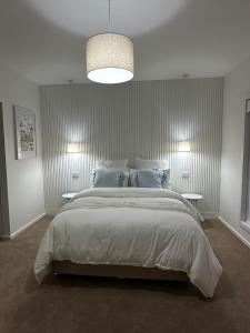 a bedroom with a large bed with blue pillows at Straun Street House in Naracoorte
