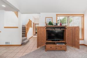 een woonkamer met een tv op een houten entertainmentcentrum bij Getaway in Pacific City