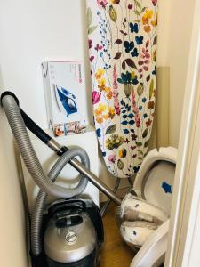 a bathroom with a vacuum cleaner next to a toilet at Lafya : ParisNord, Villepinte, CDG, StadedeFrance in Le Blanc-Mesnil +31 photos