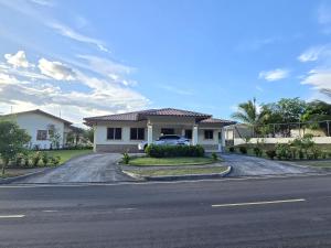 a house with a car parked in the driveway at Cozy, Quiet & Spacious 4bd 3 bth Full Home Gated Community in Los Algarrobos