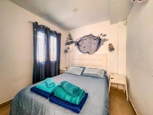 a bedroom with a bed with blue towels on it at Arthouse Sea View - Acquamarina e Zaffiro in Puerto del Carmen +55 photos