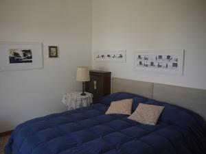 Un pat sau paturi într-o cameră la Villetta Rosetta