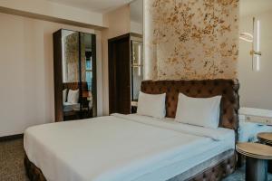 Łóżko lub łóżka w pokoju w obiekcie Highgarden Hotel