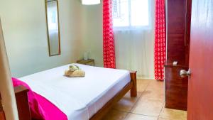a bedroom with a bed with a stuffed animal on it at Guests Favourite Apartments in Julianadorp