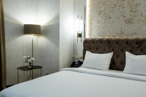 Łóżko lub łóżka w pokoju w obiekcie Highgarden Hotel