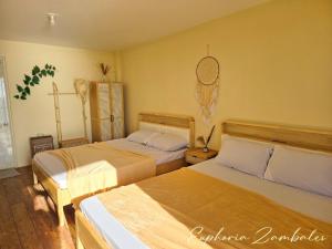 a hotel room with two beds in a room at Euphoria Zambales in Botolan