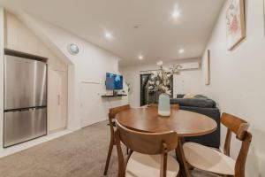 a living room with a table and a couch at 2BR Stay in the City Free Wi-Fi - Gloucester in Christchurch +37 photos