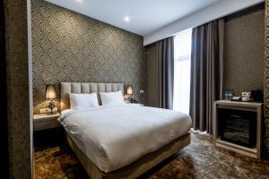 Łóżko lub łóżka w pokoju w obiekcie Highgarden Hotel