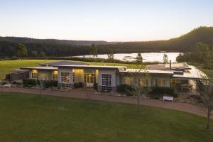 a large house with a view of a lake at Lake David Luxury Lakehouse in Kangaroo Valley