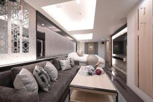 ein Wohnzimmer mit einer Couch und einem Bett in der Unterkunft HOTELみなと-Minato- 麻布十番 in Tokio