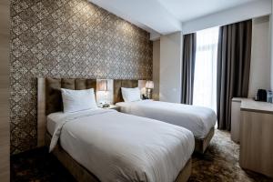 Łóżko lub łóżka w pokoju w obiekcie Highgarden Hotel