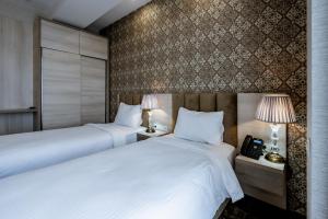 Łóżko lub łóżka w pokoju w obiekcie Highgarden Hotel