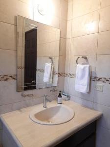 a bathroom with a sink and a mirror at Cozy, Quiet & Spacious 4bd 3 bth Full Home Gated Community in Los Algarrobos +30 photos