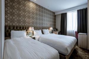 Łóżko lub łóżka w pokoju w obiekcie Highgarden Hotel