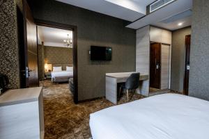 Łóżko lub łóżka w pokoju w obiekcie Highgarden Hotel