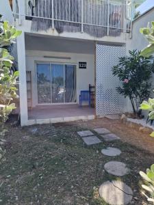 a house with a balcony and a patio at Beautiful F2 in a blue beach residence in Oyster Pond