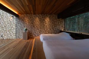 Ein Bett oder Betten in einem Zimmer der Unterkunft 奥武雄温泉　風の森