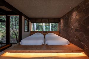 Ein Bett oder Betten in einem Zimmer der Unterkunft 奥武雄温泉　風の森