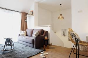 a living room with a couch and a chair at Kananta Home in Bongkar 2